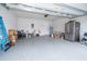 Spacious two-car garage with epoxy flooring, refrigerator, overhead storage, and ample space at 1092 Sugarwood St, Davenport, FL 33837