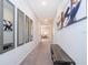 Hallway with neutral colored carpet and paint, decorated with contemporary art and mirrors at 1092 Sugarwood St, Davenport, FL 33837