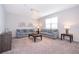 Bright living room featuring two comfortable sofas, and elegant chandelier fixture at 1092 Sugarwood St, Davenport, FL 33837