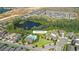Aerial shot featuring the community's amenity center, swimming pool, and scenic pond views at 12067 Eastmoor Dr, Winter Garden, FL 34787