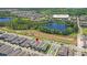 Aerial shot showcasing homes near the amenity center, swimming pool, and a scenic pond at 12067 Eastmoor Dr, Winter Garden, FL 34787