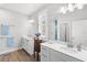 Bright bathroom featuring dual sinks, white cabinets, quartz countertops, and wood-look tile floors at 12067 Eastmoor Dr, Winter Garden, FL 34787