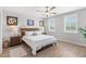 Cozy bedroom with a ceiling fan, plantation shutters, and light-colored flooring at 12067 Eastmoor Dr, Winter Garden, FL 34787