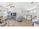 Spacious bonus room with ceiling fan, a play area and stairway leading to lower level at 12067 Eastmoor Dr, Winter Garden, FL 34787