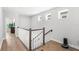 Upstairs hallway features wood-look floors and a staircase with white spindles at 12067 Eastmoor Dr, Winter Garden, FL 34787