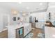 Bright kitchen with white cabinets, stainless appliances, large island, and modern fixtures at 12067 Eastmoor Dr, Winter Garden, FL 34787