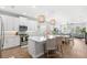 Bright kitchen featuring white cabinets, stainless appliances, island with quartz countertop and pendant lights at 12067 Eastmoor Dr, Winter Garden, FL 34787