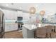 Modern kitchen featuring white cabinetry, an island with seating, and designer pendant lighting at 12067 Eastmoor Dr, Winter Garden, FL 34787