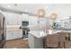 Bright kitchen featuring white cabinets, stainless appliances, island with quartz countertop and pendant lights at 12067 Eastmoor Dr, Winter Garden, FL 34787