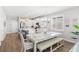 Open kitchen and dining area boasts white cabinets, a large island, and wood-look floors at 12067 Eastmoor Dr, Winter Garden, FL 34787