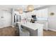 Modern kitchen featuring white cabinetry, stainless steel appliances, and an island with seating at 12067 Eastmoor Dr, Winter Garden, FL 34787