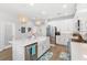 Bright kitchen featuring white cabinets, stainless appliances, island with quartz countertop and pendant lights at 12067 Eastmoor Dr, Winter Garden, FL 34787
