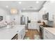 Bright kitchen featuring white cabinets, stainless appliances, island with quartz countertop and pendant lights at 12067 Eastmoor Dr, Winter Garden, FL 34787