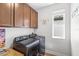 Well-equipped laundry room with modern washer and dryer, ample counter space, and bright window at 12067 Eastmoor Dr, Winter Garden, FL 34787