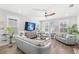 Cozy living room features comfortable seating, a ceiling fan, and wood-look floors at 12067 Eastmoor Dr, Winter Garden, FL 34787