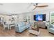 Bright and airy living room open to kitchen, with wood-look floors and comfortable seating at 12067 Eastmoor Dr, Winter Garden, FL 34787