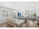 Bright living space features a dining table, living room seating, and wood-look floors at 12067 Eastmoor Dr, Winter Garden, FL 34787