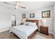Comfortable main bedroom features a ceiling fan, wood-look floors, and ensuite bathroom at 12067 Eastmoor Dr, Winter Garden, FL 34787