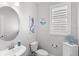 Stylish powder room with a modern sink and charming mermaid-themed decor at 12067 Eastmoor Dr, Winter Garden, FL 34787
