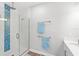 Modern bathroom featuring a glass-enclosed shower with blue accent tiles at 12067 Eastmoor Dr, Winter Garden, FL 34787
