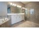Bright bathroom featuring double sinks, shower, tub, and modern gray tile at 12334 Upper Harden Ave, Orlando, FL 32827