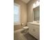 Bathroom featuring white vanity, toilet, and tiled floors and a window with shutters at 12334 Upper Harden Ave, Orlando, FL 32827
