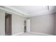 Open bedroom with crown molding and access to closet space at 12334 Upper Harden Ave, Orlando, FL 32827