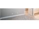 Neutral bedroom featuring plush carpet, white trim, and a door to an ensuite bathroom at 12334 Upper Harden Ave, Orlando, FL 32827