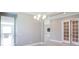 Elegant dining room featuring a modern chandelier and access to other rooms in the house at 12334 Upper Harden Ave, Orlando, FL 32827
