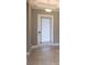 Close-up of the bright entryway with tray ceiling and a glass paneled front door at 12334 Upper Harden Ave, Orlando, FL 32827