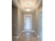 Bright entryway with tray ceiling, neutral paint, and a glass paneled front door at 12334 Upper Harden Ave, Orlando, FL 32827