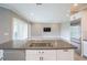 Kitchen featuring stainless steel appliances, white cabinets, an island with a sink and living area access at 12334 Upper Harden Ave, Orlando, FL 32827