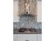 Close-up of a modern gas range and stainless steel range hood with a decorative backsplash at 12334 Upper Harden Ave, Orlando, FL 32827