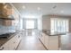 Modern kitchen boasting white cabinets, stainless steel appliances, and a stylish backsplash at 12334 Upper Harden Ave, Orlando, FL 32827
