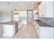 Spacious kitchen featuring white cabinetry, stainless appliances, and a gray countertop island at 12334 Upper Harden Ave, Orlando, FL 32827