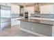 Bright kitchen featuring white cabinets, a large island and stainless steel appliances at 12334 Upper Harden Ave, Orlando, FL 32827