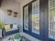 A charming balcony with cozy seating, plants, and decorative wall hangings at 12955 Cats Claw Ln, Orlando, FL 32828