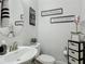 A cozy bathroom featuring decorative wall art, a toilet, and a sink with stylish fixtures at 12955 Cats Claw Ln, Orlando, FL 32828