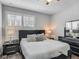 A cozy bedroom featuring a plush bed, side tables, and a dark wood dresser and accents at 12955 Cats Claw Ln, Orlando, FL 32828