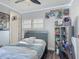 A bedroom featuring comic book decorations, a bed, and a computer desk at 12955 Cats Claw Ln, Orlando, FL 32828