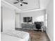 Bedroom featuring a large flat screen, ceiling fan, and an office area with natural lighting at 12955 Cats Claw Ln, Orlando, FL 32828