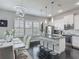 Contemporary dining area open to the kitchen, featuring modern lighting and white cabinetry at 12955 Cats Claw Ln, Orlando, FL 32828