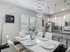 Stylish dining area featuring modern lighting, a sleek table setting, and an open view to the kitchen at 12955 Cats Claw Ln, Orlando, FL 32828