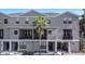 Elegant three-story townhome with well-maintained landscaping and private balconies for outdoor enjoyment at 12955 Cats Claw Ln, Orlando, FL 32828