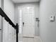 Bright foyer with tile flooring, leading to the main living areas, and the front door at 12955 Cats Claw Ln, Orlando, FL 32828