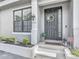 Charming home exterior featuring a decorative wreath, manicured shrubs, and inviting entrance at 12955 Cats Claw Ln, Orlando, FL 32828