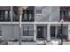 Elegant townhome exteriors with private balconies, complemented by manicured landscaping and inviting entrances at 12955 Cats Claw Ln, Orlando, FL 32828