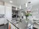 This kitchen boasts modern light fixtures, an island with seating, and stainless steel appliances at 12955 Cats Claw Ln, Orlando, FL 32828