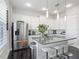 Charming kitchen with white cabinets, stainless steel appliances, and a center island with breakfast bar at 12955 Cats Claw Ln, Orlando, FL 32828