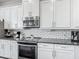 Modern kitchen with stainless steel appliances, white cabinetry, and stylish countertops at 12955 Cats Claw Ln, Orlando, FL 32828